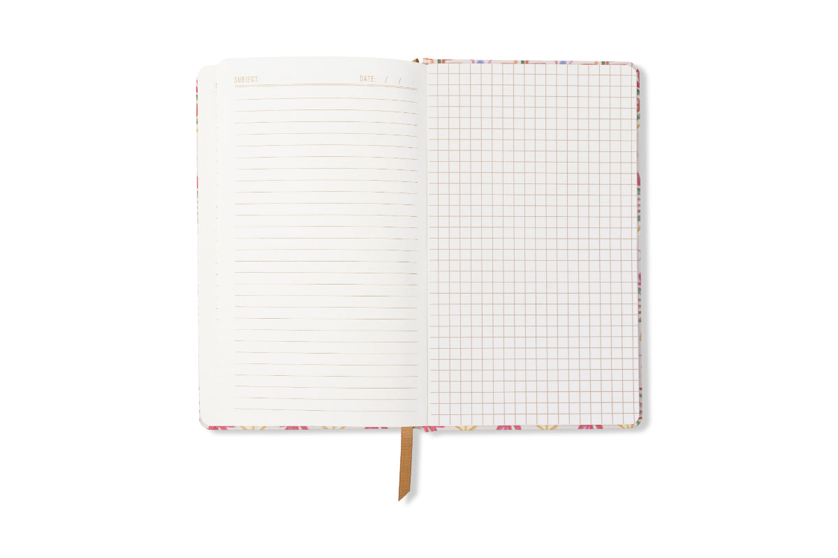 The Tulip Journal - Tropical is open, revealing a lined left page and a squared grid right page, with a ribbon bookmark at the bottom. The background is white.