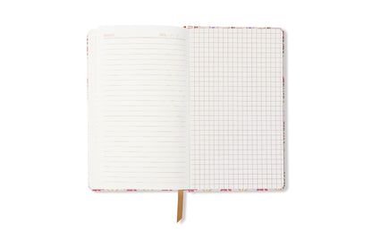 The Tulip Journal - Tropical is open, revealing a lined left page and a squared grid right page, with a ribbon bookmark at the bottom. The background is white.