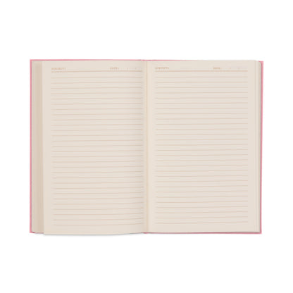 The It’s All Going Swell Journal is pictured open, displaying its blank lined pages with designated sections for Subject and Date at the top. Featuring a pink bookcloth cover and lay-flat binding for easy writing, the journal sits against a white background.