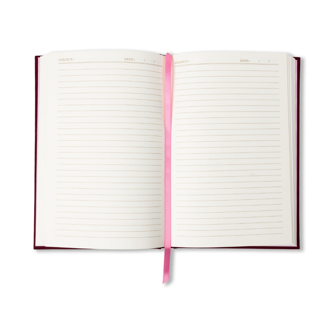 The “I Don’t Cook Journal” features an open layout with lined pages, a centrally placed pink ribbon bookmark, and designated sections at the top for Subject and Date. Its dark red cover evokes the charm of a vintage book-inspired journal.