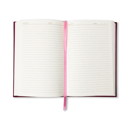 The “I Don’t Cook Journal” features an open layout with lined pages, a centrally placed pink ribbon bookmark, and designated sections at the top for Subject and Date. Its dark red cover evokes the charm of a vintage book-inspired journal.