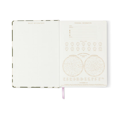 The Soft Touch Jumbo Journal - Bold Stripe lies open, displaying a dotted index page and a personal information page with world time zones, constellations, and astronomical references, marked by a ribbon bookmark at the bottom.