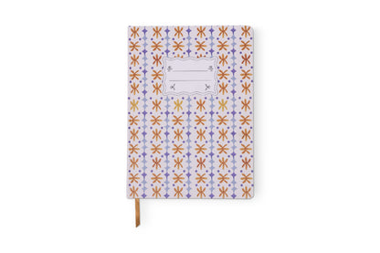 The Tulip Jumbo Journal - Marigold features a jumbo size, decorative cover with a repeating orange, yellow, and purple pattern, a blank label at the top center, and a brown ribbon bookmark.