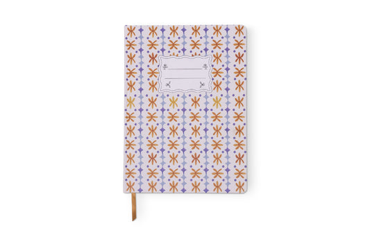 The Tulip Jumbo Journal - Marigold features a jumbo size, decorative cover with a repeating orange, yellow, and purple pattern, a blank label at the top center, and a brown ribbon bookmark.