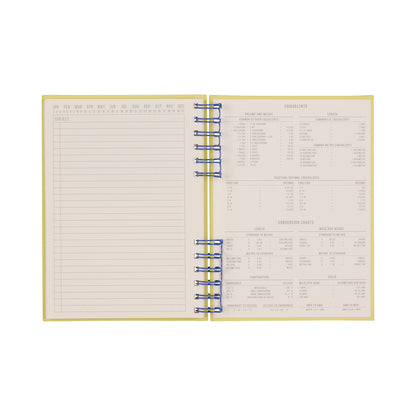 The Standard Issue Planner Notebook No. 12 - Cobalt + Citron is expertly crafted, featuring a blank lined page on the left and measurement conversion charts printed on the right, ensuring a premium writing experience.