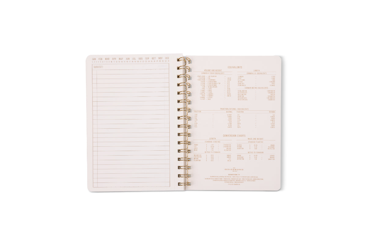 An open Tulip Twin Wire Notebook - Small Blue Lattice shows a blank lined notes page with perforations on the left and a kitchen measurement conversion chart with various units and equivalents on the right.