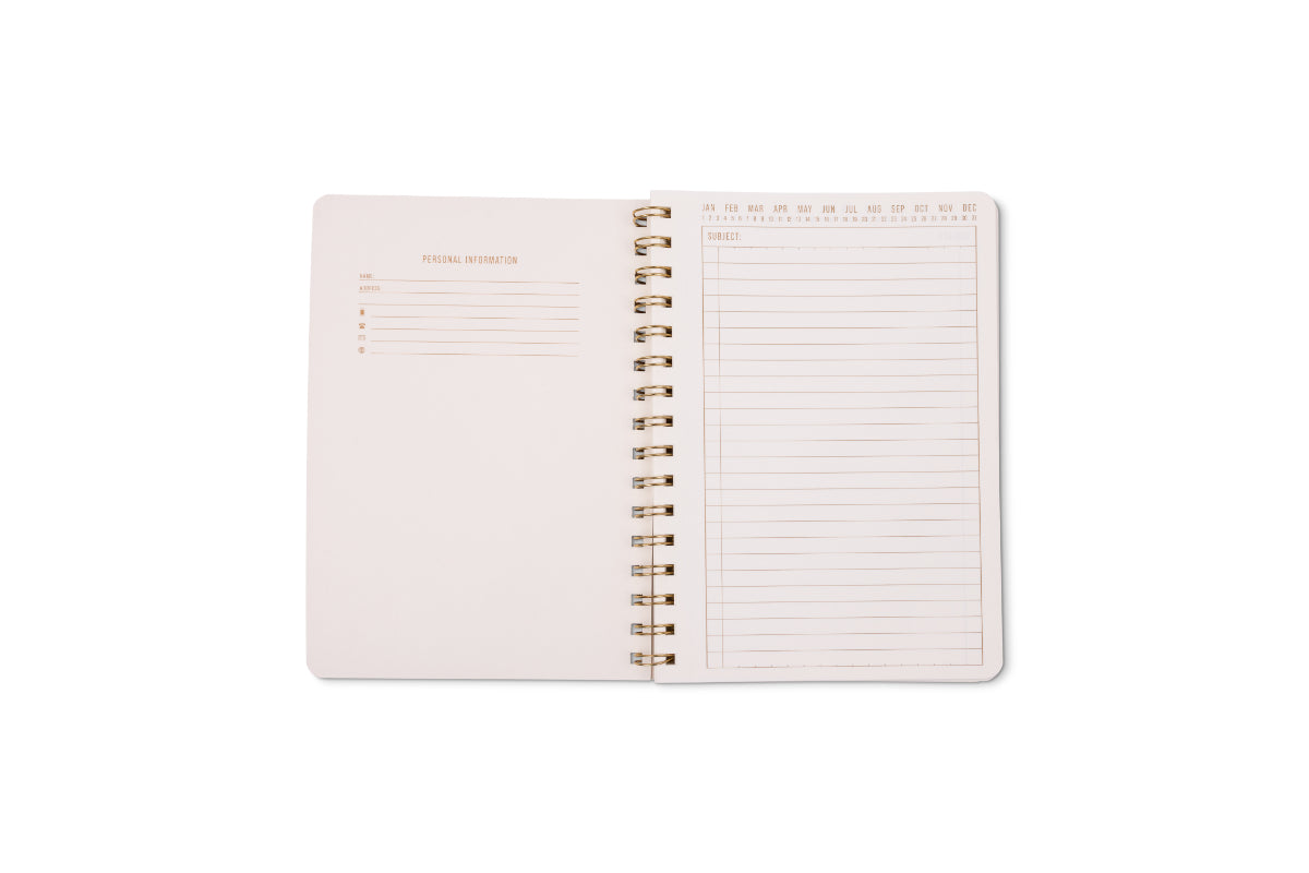 An open Tulip Small Twin Wire Notebook - Pinwheel Pink displays twin-wire binding, a personal info section on the left, and lined perforated pages with a date header for notes on the right, all on a white background.