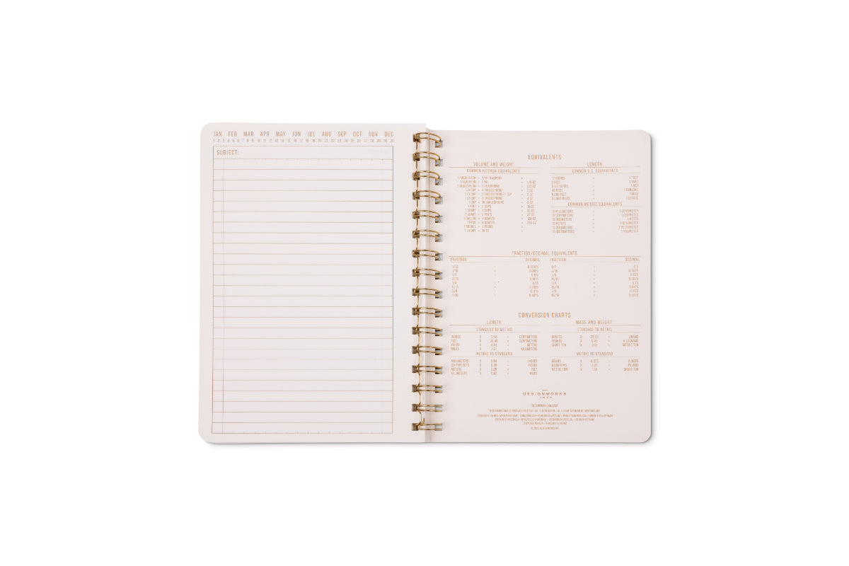 An open Tulip Small Twin Wire Notebook in Pinwheel Pink shows a lined, perforated page on the left and measurement conversion charts on the right, all set against a white background.