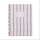 The Tulip Twin Wire Notebook - Large Wavy Blue features a light pink cover with wavy blue, green, and purple dotted patterns, a white name label, lined perforated pages, and sturdy twin-wire binding for convenient note-taking.