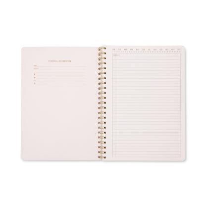 An open Tulip Twin Wire Notebook - Large Orange Check is displayed, showcasing a personal information page on the left and a lined notes page with columns for date and days of the week on the right. The lined, perforated pages and vibrant large orange check cover provide both convenience and style for your everyday organization.