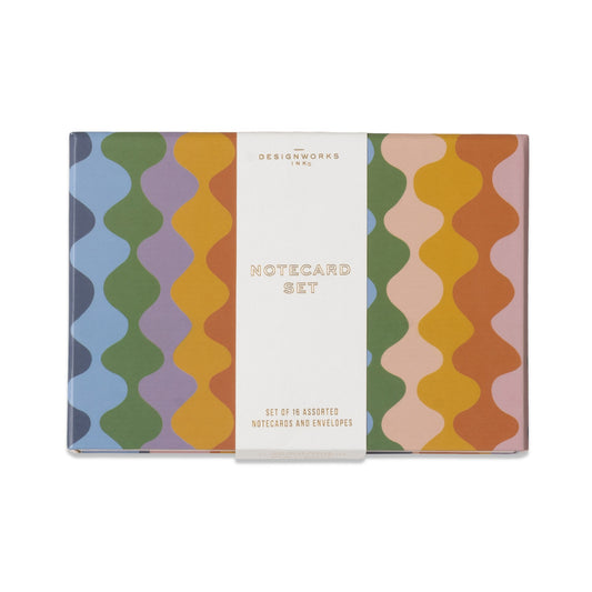 The Boxed A Dopo Notecard Set - 16 cards is a premium stationery collection showcasing a wavy striped pattern in blue, purple, green, yellow, orange, and pink. A white band across the center displays “Notecard Set” in elegant gold text, making it a stylish and thoughtful addition to any desk or gift box.