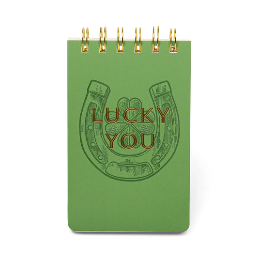 The Vintage Sass Notepad - Lucky you features a green cover with an embossed horseshoe and the phrase Lucky You, giving it retro charm and a lucky vibe.
