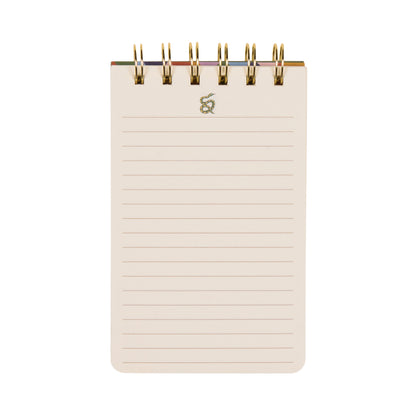 A Dopo Twin Wire Notepad - Snake is a compact, spiral-bound notepad with lined cream-colored pages and a gold twin wire binding at the top. The cover features Mediterranean-inspired hand-drawn snake designs, shown against a white background.