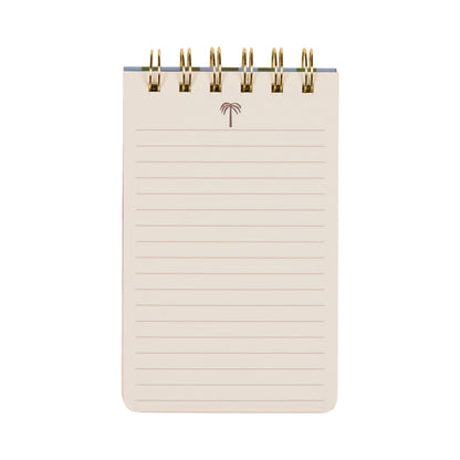 The A Dopo Twin Wire Notepad - Palm is a small, spiral-bound notepad featuring lined pages and a minimalist Mediterranean-inspired palm tree illustration centered at the top. Its beige background provides a stylish touch, making it perfect for jotting down notes.
