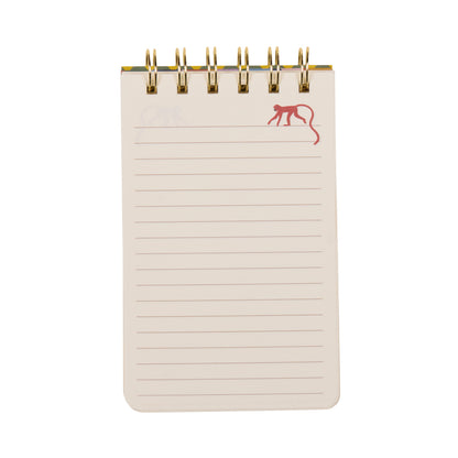 A Dopo Twin Wire Notepad - Monkey features a small spiral-bound format with lined pages and a playful red outline drawing of a monkey in the top right corner. The notepad showcases charming hand-drawn designs on a white background.