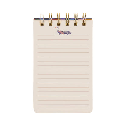 The A Dopo Twin Wire Notepad - Peacock is a small, spiral-bound notepad with lined pages and a distinctive purple peacock illustration at the top, showcasing unique hand-drawn designs inspired by Mediterranean stationery, all set against a clean white background.