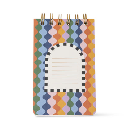 Introducing the A Dopo Twin Wire Notepad - Horse: a small, compact notepad adorned with a vibrant wavy pattern in orange, blue, green, purple, and pink. Its cover showcases an arched label featuring black and white stripes along with horizontal lines for writing, making it a stylish addition to your Mediterranean-inspired stationery collection.