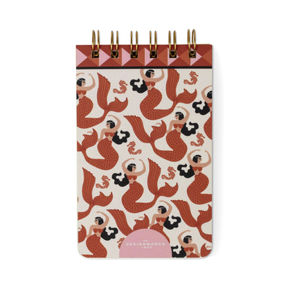 The A Dopo Mermaid & Moon Twin Wire Notepad is a compact notepad with a cover showcasing an illustrated pattern of red mermaids and seashells. Its top features a geometric design and sturdy gold twin wire binding, while the note pages are crafted from eco-friendly, acid-free stationery materials.