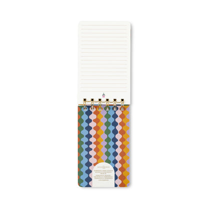 Introducing the A Dopo Blue Cheetah Twin Wire Notepad—a compact, vertically-opening notepad bound with gold rings. The bottom cover showcases a vibrant wavy design in blue, green, yellow, and purple hues. Crafted from acid-free paper, each top page is lined for neat writing.