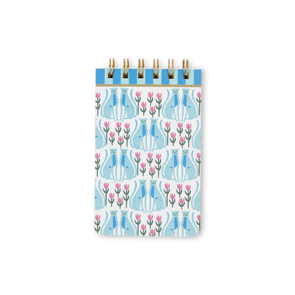 Introducing the A Dopo Blue Cheetah Twin Wire Notepad—a small, eco-friendly stationery notepad with a sturdy spiral binding and a charming cover design featuring blue cheetahs and pink florals against a crisp white background. Compact and convenient for jotting down notes on the go, this notepad contains acid-free paper to keep your writing preserved over time.