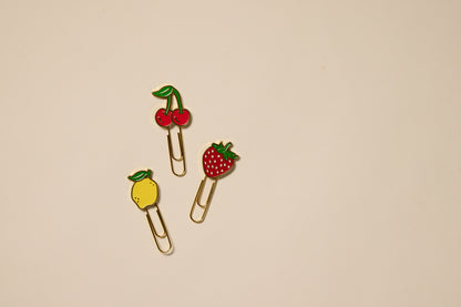 The Set of 3 Paperclips - Fruit features gold clips topped with cherry, strawberry, and lemon decorations, perfect for adding charm to your planner or using as fun office accessories.