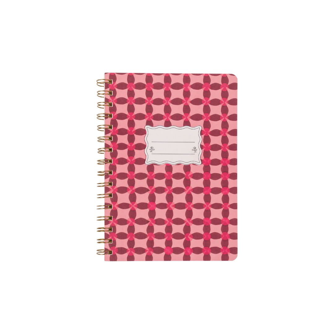 The Tulip Twin Wire Notebook - Small Pinwheel Pink features a twin-wire binding, a pink and red geometric pinwheel flower cover, and a blank white center label ideal for writing your name or subject.