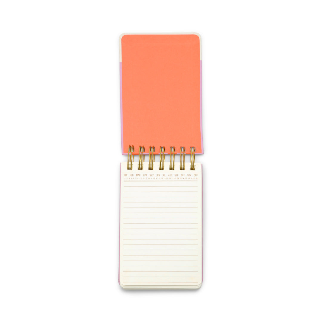The Chunky Small Twin Wire Notepad - Stripes is flipped open to reveal its lined white pages, showcasing its compact, chunky design and colorful striped twin wire binding, as seen from above on a white background.