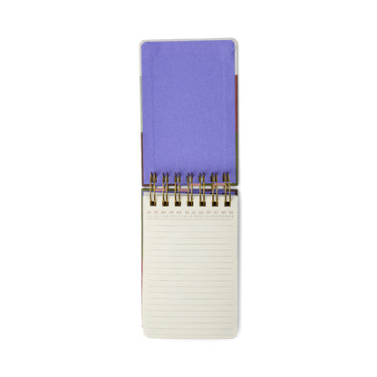 The Chunky Small Twin Wire Notepad – Bold Stripes is open to reveal a blank lined page at the bottom, while its bold, colorful hard cover rests on top, all set against a clean white background.