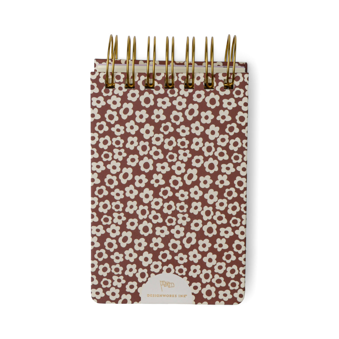 Introducing the Chunky Small Twin Wire Notepad in Burgundy Groovy Floral—a compact, spiral-bound notepad with a sturdy burgundy cover adorned with a playful floral pattern and a gold logo at the bottom center. With 192 sheets inside, it’s perfect for jotting down notes wherever you go.