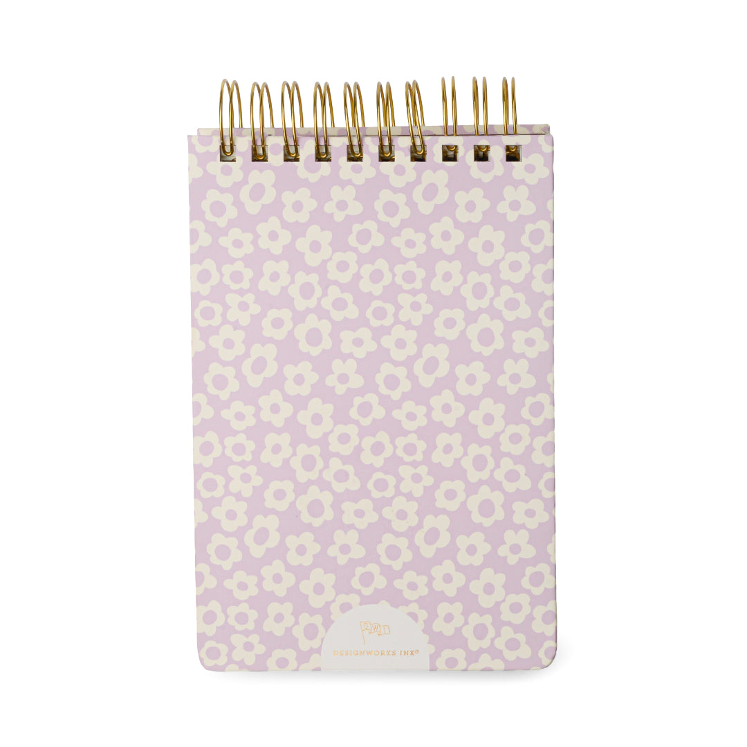 The Chunky Large Notepad - Lilac Groovy Floral is a small, chunky pocket notepad featuring a lilac groovy floral cover design. This hard cover notepad includes gold-colored wire binding at the top, rounded corners, and contains 192 sheets for ample note-taking.