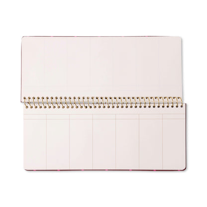 A Color Block Weekly Planner Pad - Burgundy + Pink, featuring an open spiral-bound design with blank, off-white pages sectioned into rectangles for each week, is photographed from above on a white background.