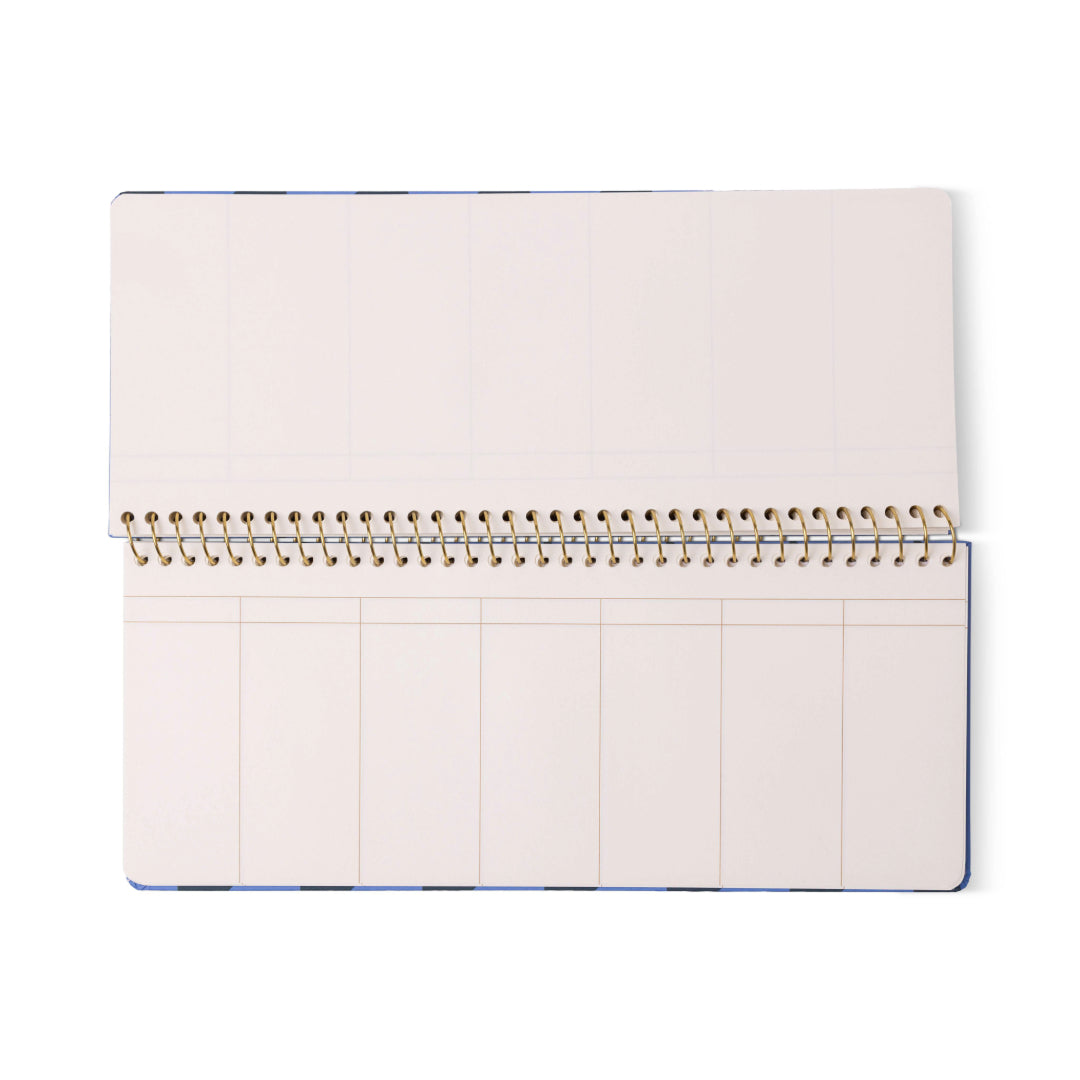 The Color Block Weekly Planner Pad - Blue + Navy features an open, spiral-bound design with undated, blank pages divided into multiple columns and accented with understated gold foil details, lying flat on a white background.