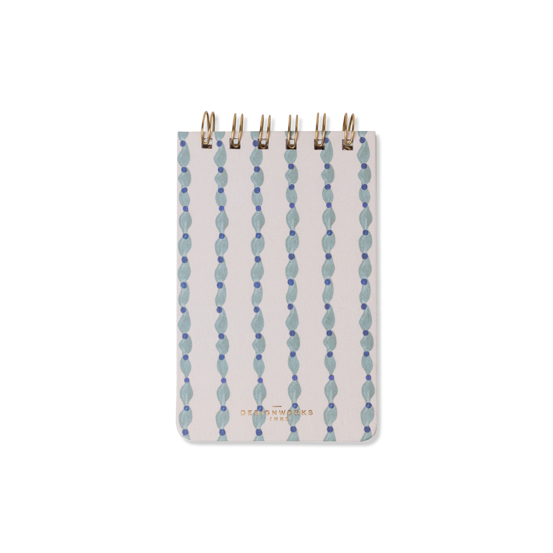 The Tulip Twin Wire Notepad - Wavy Blue features a small format, gold twin-wire binding, and a cover with wavy blue and purple lines on white. Its lined pages are perfect for quick notes or sketches, making it ideal for any workspace.