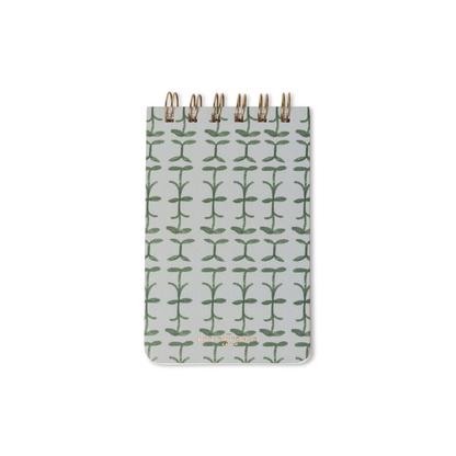 The Tulip Twin Wire Notepad - Green Vine is a small notepad with a white cover featuring a repeating green vine pattern, centered on a plain white background.