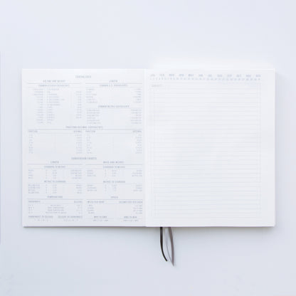 The Standard Issue Notebook No.3 - Green features sturdy construction, measurement conversion charts on the left, and a right-hand lined page labeled Subject and months—ideal for an elevated writing experience.