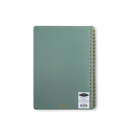 A Textured Paper Twin Wire Notebook - Large Juniper with gold-colored twin wire binding and a white barcode sticker on the green flex cover, photographed on a white background.